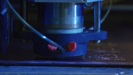 Powerful laser engraving machine precisely etching intricate design onto metal surface, showcasing...