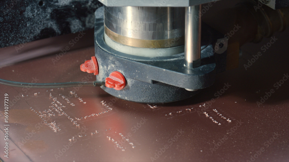 Poster industrial milling machine engraving an electronic circuit board, creating precise pathways for comp