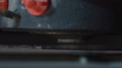 Close up view of an orbital sander expertly smoothing a wooden plank in a workshop, highlighting the intricate process of woodworking and achieving a flawless surface finish
