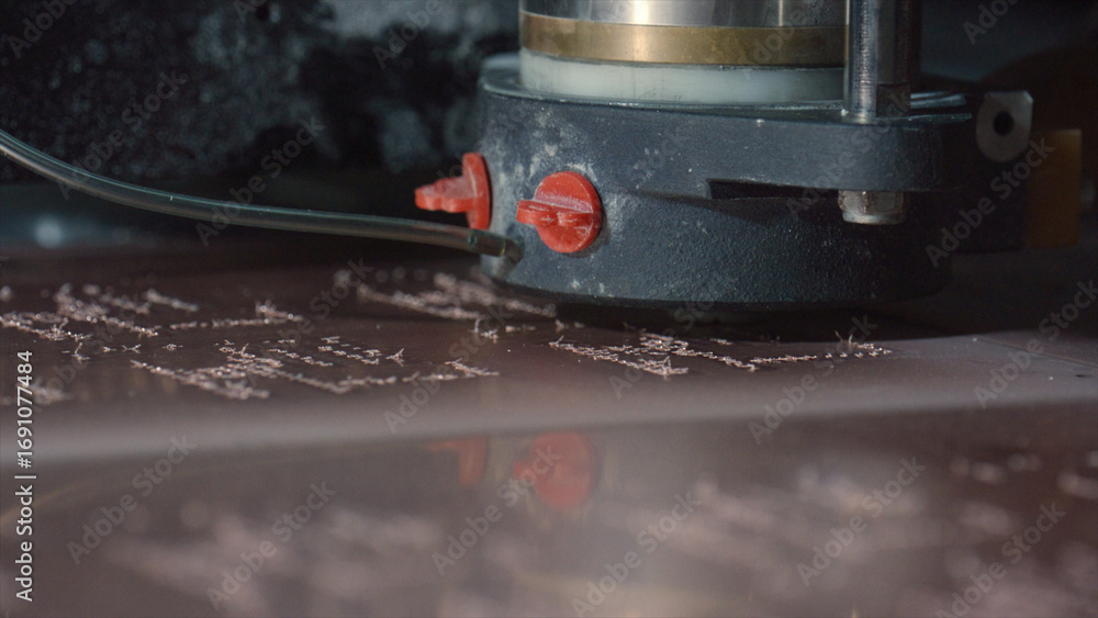 Poster industrial milling machine is precisely engraving a metal surface, creating an intricate design with