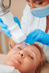 Laser resurfacing and peeling of facial skin - cosmetic medical procedure in a beauty salon