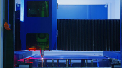 Automated industrial laser engraving acrylic sheet in modern factory, showcasing precision and...