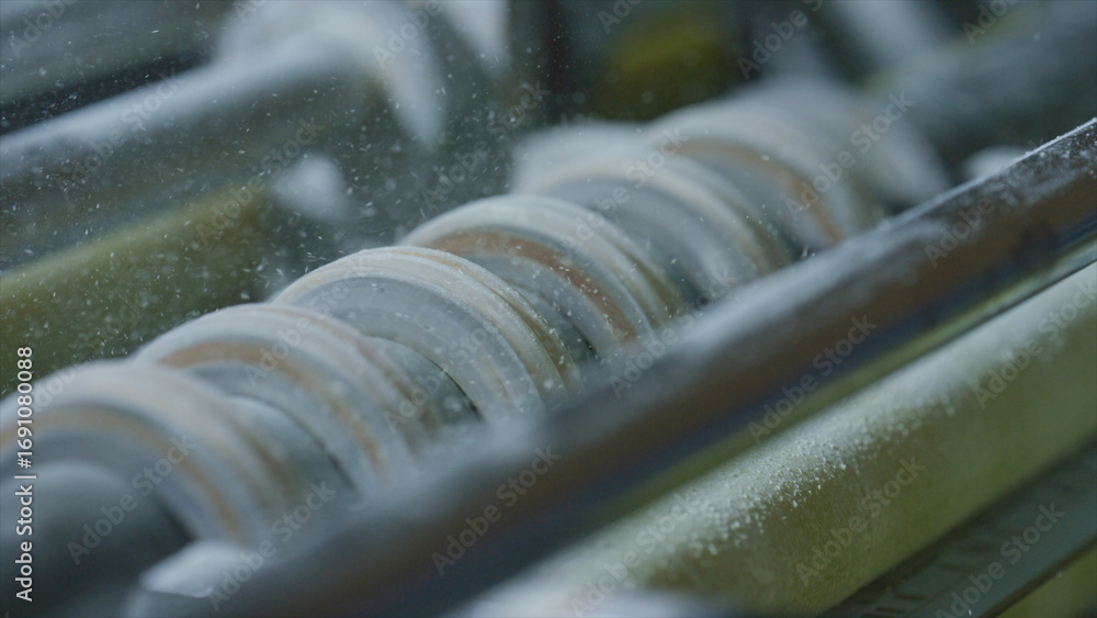 Poster rotating rollers process material in a factory, showcasing industrial manufacturing processes and hi