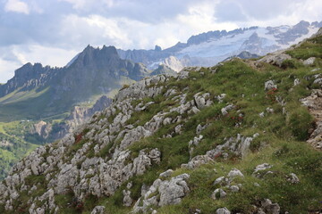 Trentino, Italy - July 29, 2025: Stunning Alpine scenery of breathtaking Dolomites rocks mountains in Italian Alps. Marmolada glacier seen in the distance from the slopes of the Porta Vescovo Dolomite