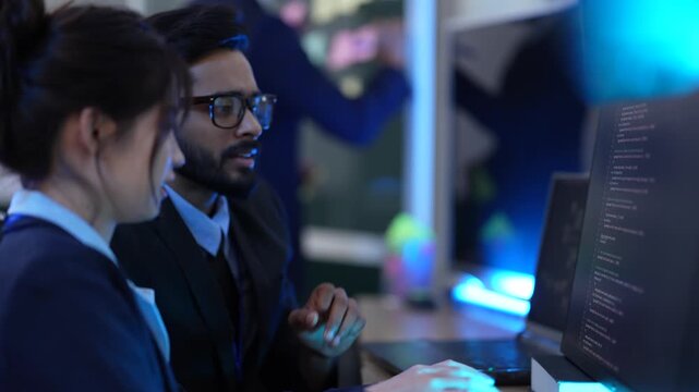 A team of AI programmers and data scientists brainstorms in a project meeting. They use sticky notes and a computer to plan the development of new artificial intelligence software.