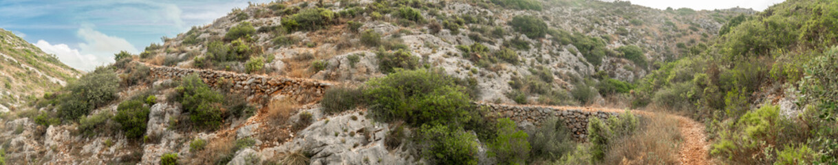 Panoramic landscape with rocky hills and a cloudy sky, in Bocairent, Comunidad Valenciana (Spain