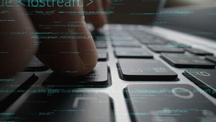 This close-up image captures fingers typing on a laptop keyboard, with digital code overlay that represents modern programming and technology in a vibrant workspace setting. Xenic