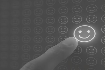 Glowing pink smiley face among many faint smileys