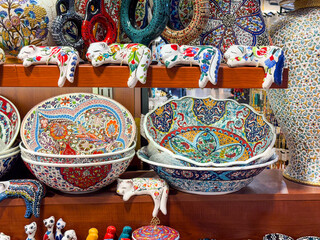 Fototapeta premium Large decorative bowls with traditional patterns displayed in a market stall. Cultural heritage, artisan pottery, and handmade craftsmanship with symbolic motifs.