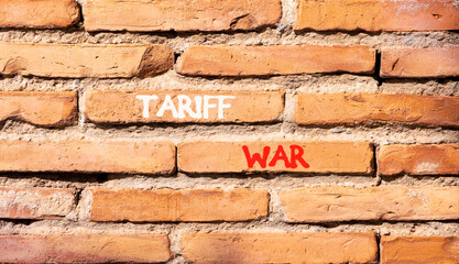 Trade tariff war symbol. Concept word Tariff war on beautiful old brown brick wall. Beautiful old brown brick wall background. Old brick wall. Business trade tariff wars concept. Copy space.