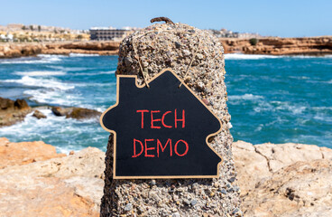 Tech demo symbol. Concept word Tech demo on beautiful black blackboard. Beautiful stone and blue...