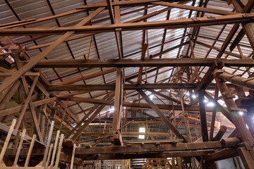 Dusty traditional wood workshop with sawdust pile