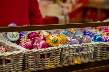 Christmas tree decorations toys on Christmas market, bright baubles and festive garlands in cozy shops, green and red decor for unique holiday sparkle,Russia, Moscow, December 16, 2024