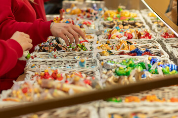 Christmas tree decorations toys on Christmas market, blue and gold baubles in cheerful markets, advent shopping with festive lights and unique gifts.
