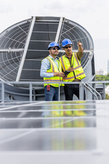 Engineers inspecting rooftop ventilation system installation