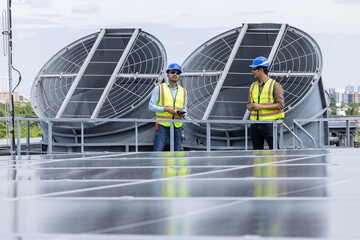 Engineers inspecting rooftop ventilation system installation