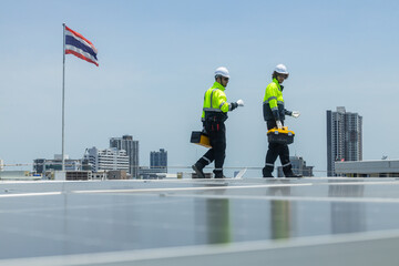 Technicians maintaining rooftop solar panel system