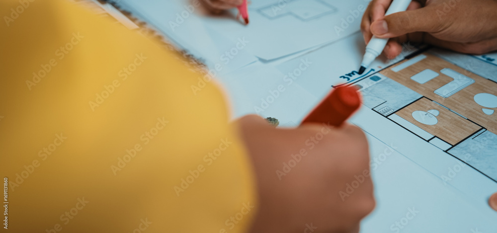 Poster a close-up view of hands engaged in a collaborative planning session using colorful markers on archi