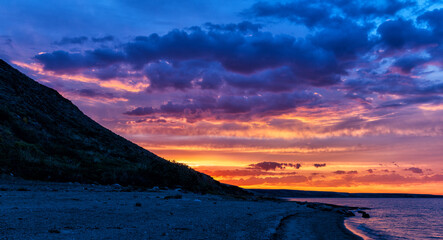 Kazakhstan, Early Dawn on Reliktov Lake Zaysan in the town of Shekelmes. The sun is hidden behind...