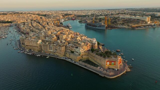 Sunset drone view of old Senglea city, marina, yachts. Malta island