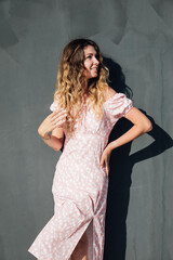 woman smiling in summer pink dress outdoors