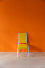 yellow vintage wall chair in an empty room