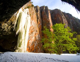 Icy waterfall cascading down a rock face