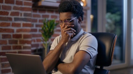 Thoughtful businessman African American guy thinking business man searching idea in evening office consider decision male trader employee think project plan online late working laptop in dark night