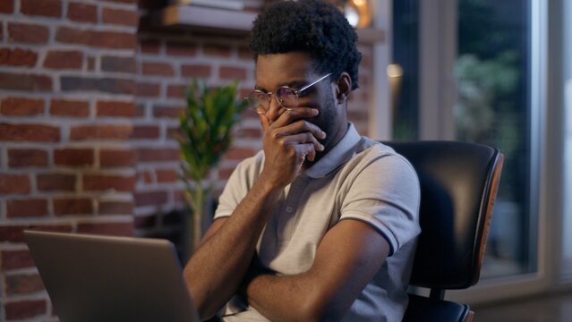 Thoughtful businessman African American guy thinking business man searching idea in evening office consider decision male trader employee think project plan online late working laptop in dark night