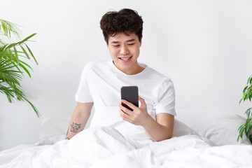 Great message, online offer, good news, positive expression in morning. Smiling asian young, teen...