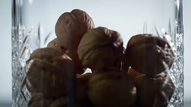 Walnuts Filling a Clear Crystal Glass Bowl in a Close Up Still Life Shot