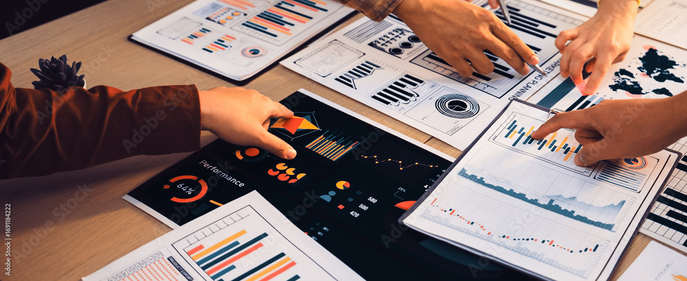 Poster a group of professionals engaging in collaborative analysis over various business charts and graphs 