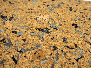 Cork tile with black and grey speckled pattern, designed for flooring or wall decoration.