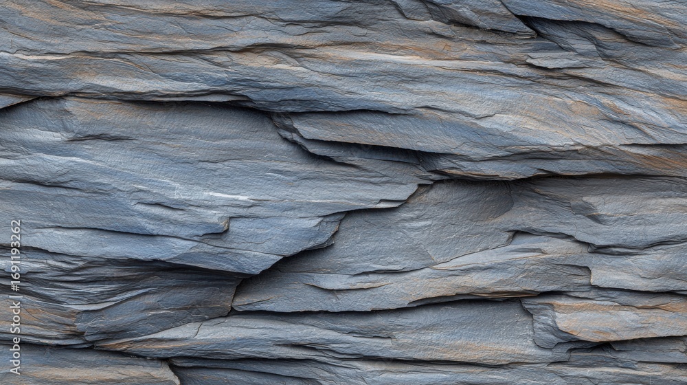 Poster a close-up view of a rock face with a textured surface and varying shades of gray and brown.
