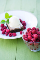 Raspberry closeup and brownie cake with ice cream and mint dessert