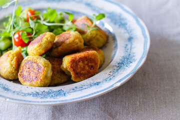 Falafel with salad on a blue plate