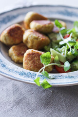 Falafel on a plate with green leaves
