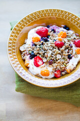 muesli with berries on an orange plate