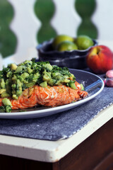 Grilled salmon with avocado salsa on top