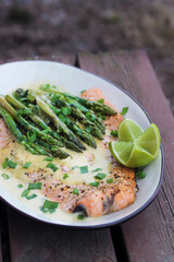Grilled salmon steak with asparagus, lime, and hollandaise sauce. 