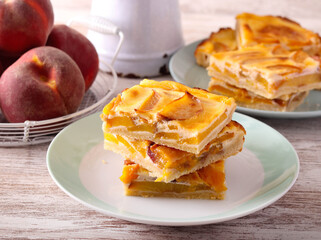 Peach cream  slices stacked on plate