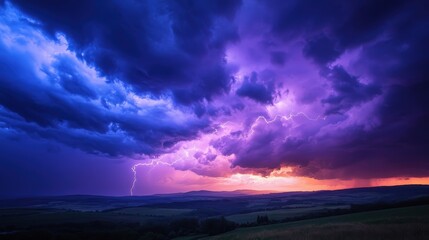Fototapeta premium Dramatic storm clouds with flashes of lightning and vibrant colors in the sky at sunset create a breathtaking natural scene.