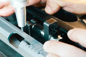 Engraving serial number on a pistol using a special numbering machine