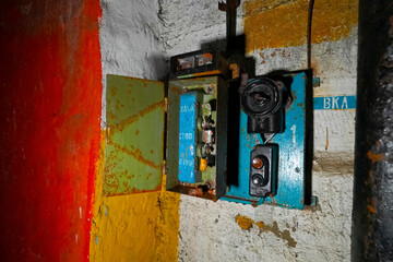 start switch is a stop on the wall of an abandoned bunker. non-working electrical equipment