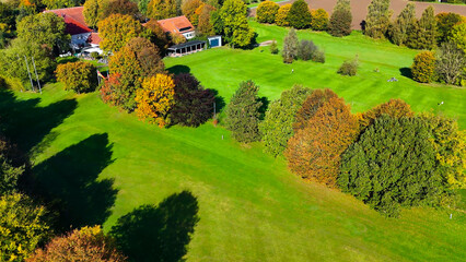 Drone view of autumn golf course in Germany.
