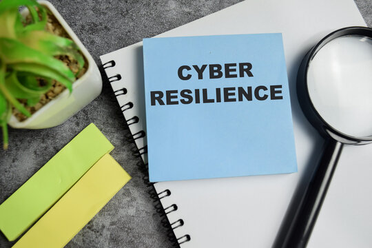Concept of cyber resilience write on sticky notes isolated on Wooden Table.