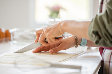 Obraz premium Woman Cutting Dough For Cookies