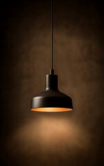 Obraz premium A minimalist black pendant light hangs from the ceiling, casting a warm, inviting glow against a neutral backdrop, illuminating the space.