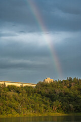 Rainbow is seen in the sky above a mountain