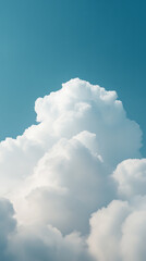 Fluffy white clouds against a serene blue sky create a peaceful, dreamlike image. The soft textures and bright hues evoke a sense of calm and wonder.